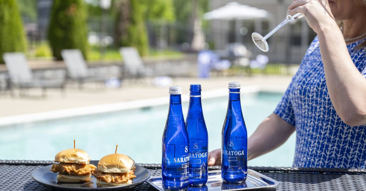 chicken sandwiches and saratoga water by pool