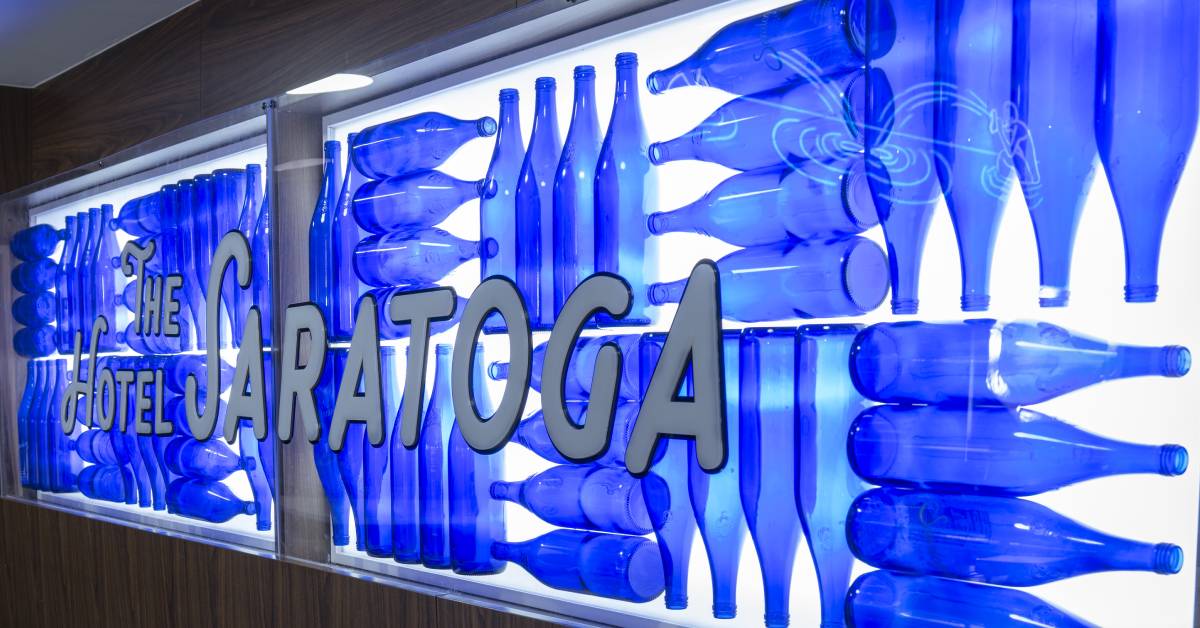 the hotel saratoga lettering with backdrop of saratoga water bottles