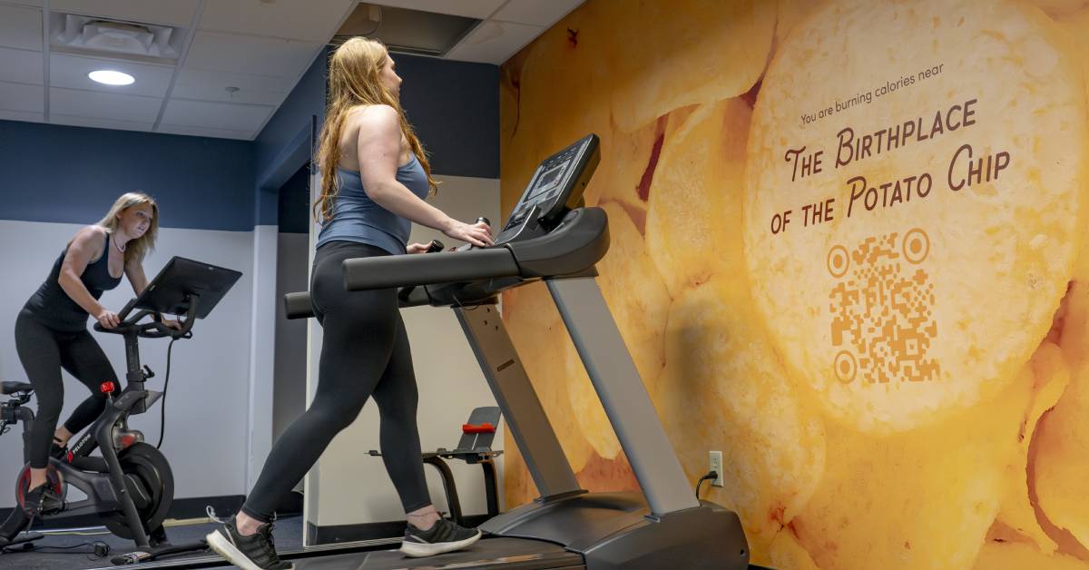 gym at hotel saratoga with birthplace of potato chip qr code on the wall