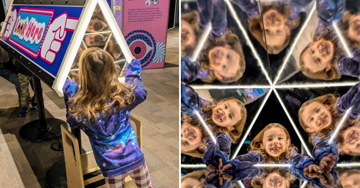 little girl looks in kaleidoscope-like exhibit