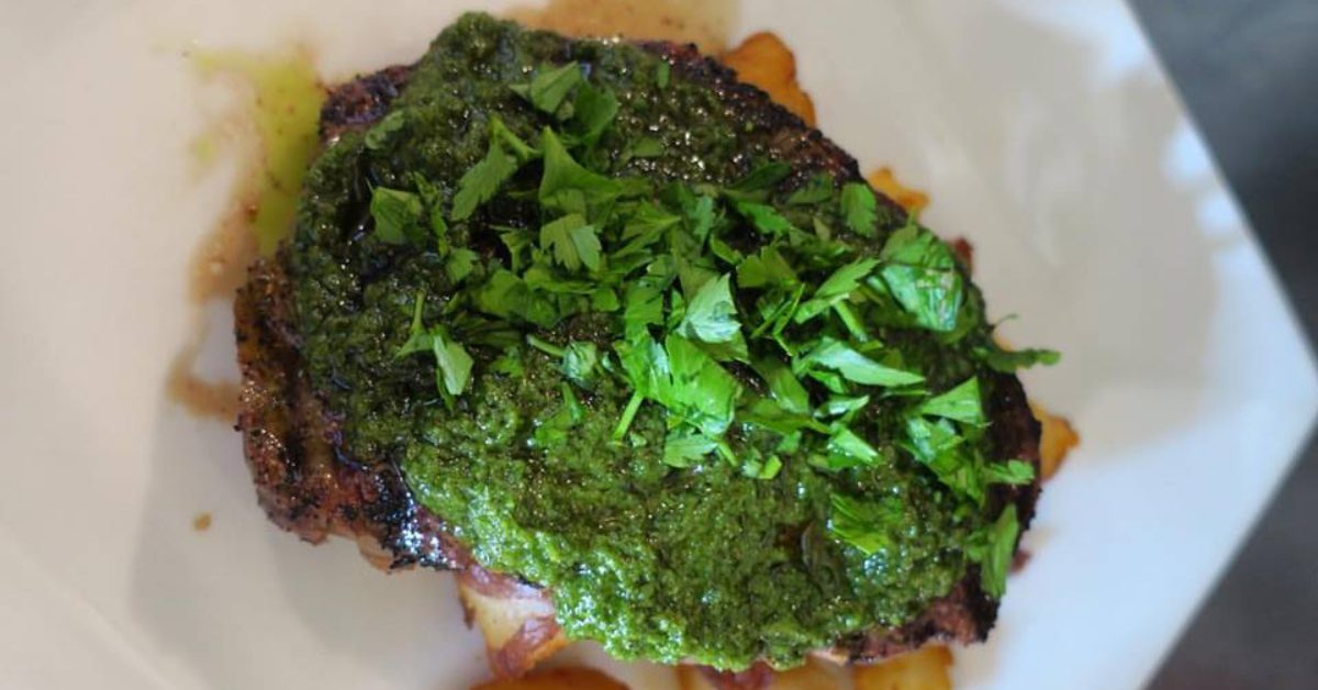 steak with green sauce and herbs