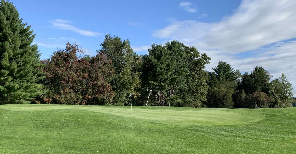 green golf course and flagpole
