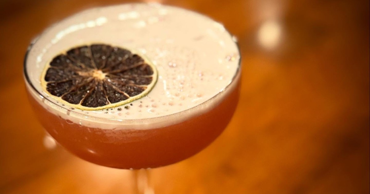 cocktail with dark orange slice
