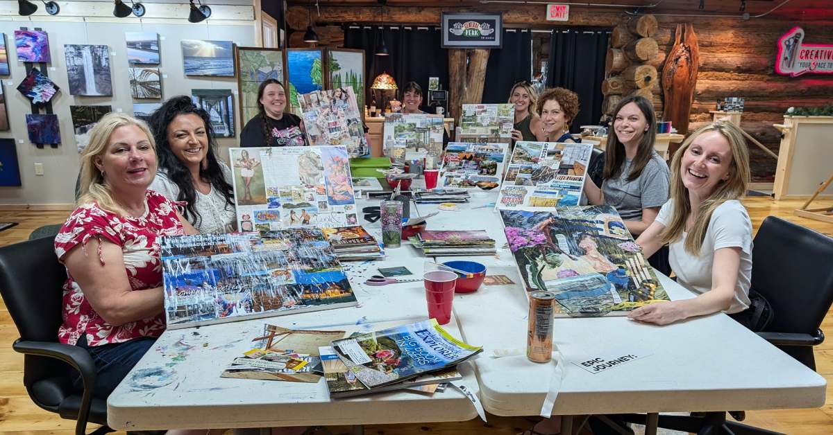 people working on artworks at a table