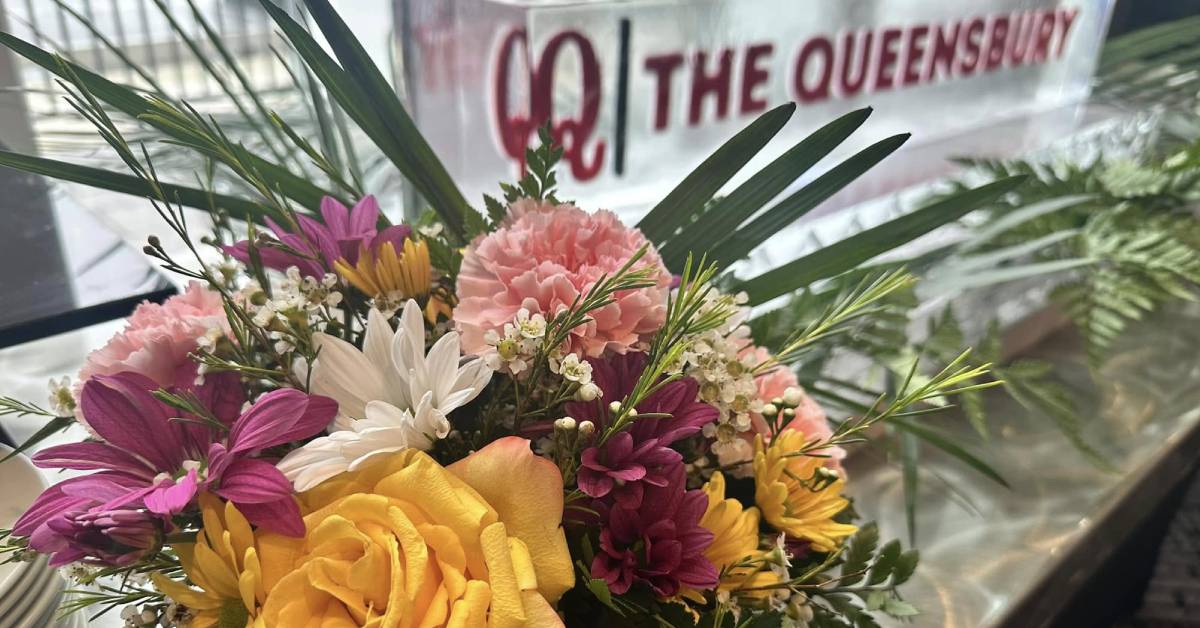 queensbury hotel sign with flowers