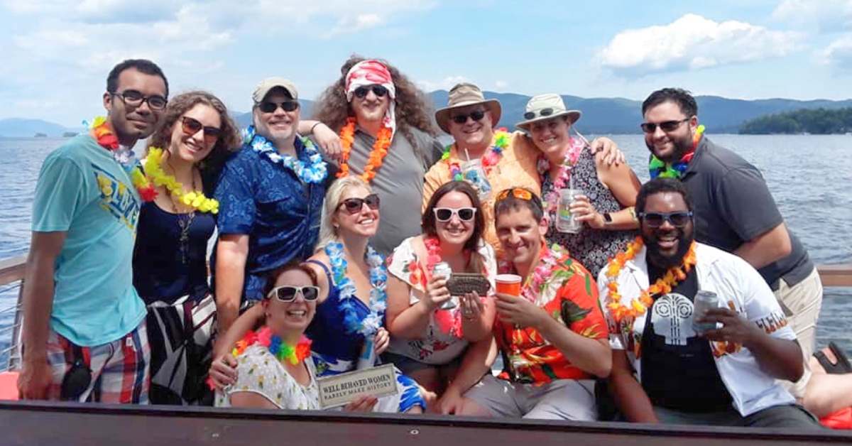 group of people dressed up for a tiki boat tour