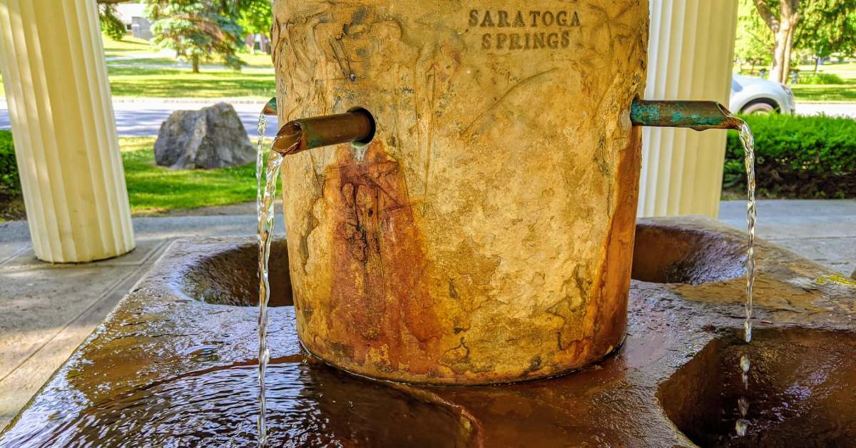 an old mineral spring fountain with flowing water