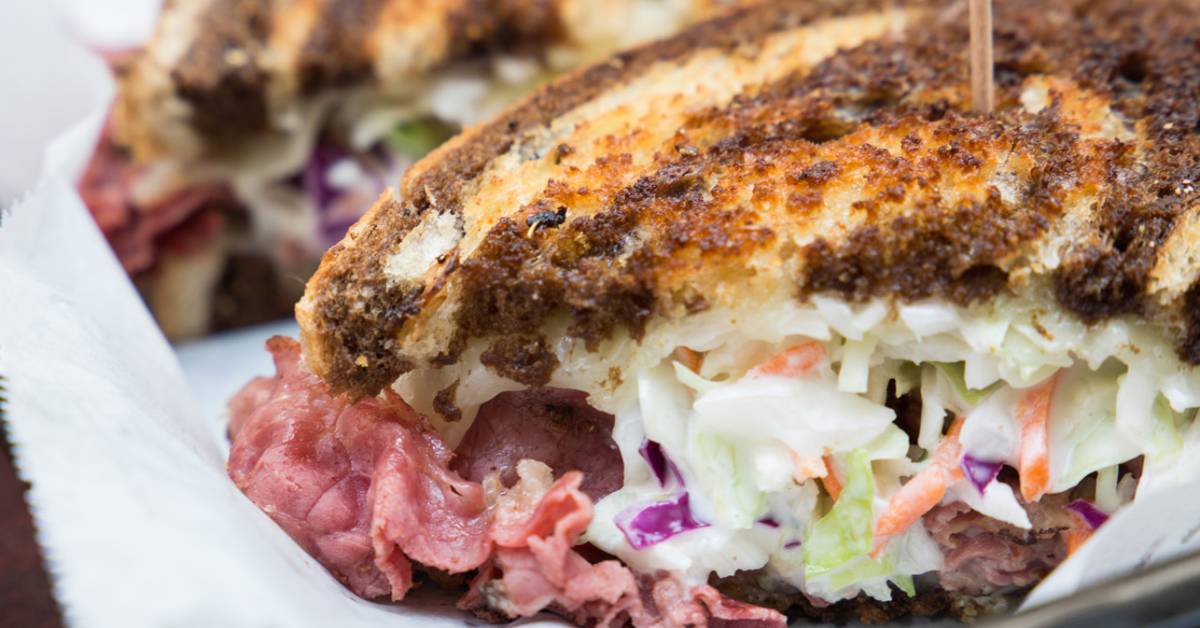 Mouth-watering sandwich on marble rye bread with coleslaw and roast beef.  