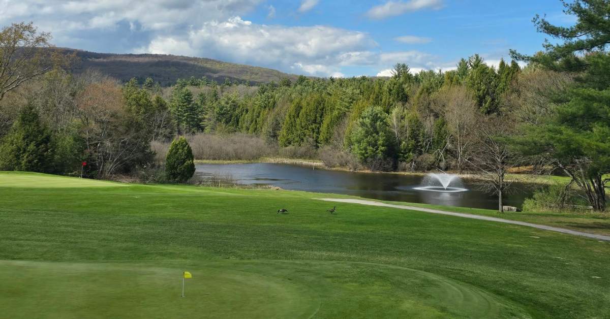 golf course with pond in the background