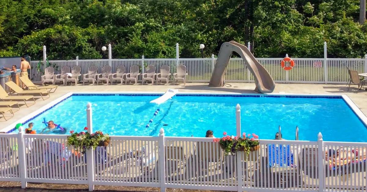 outdoor pool with waterslide at lyn aire motel