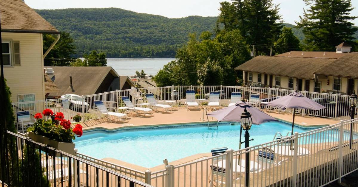 pool and lake view at nordick's inn in lake george