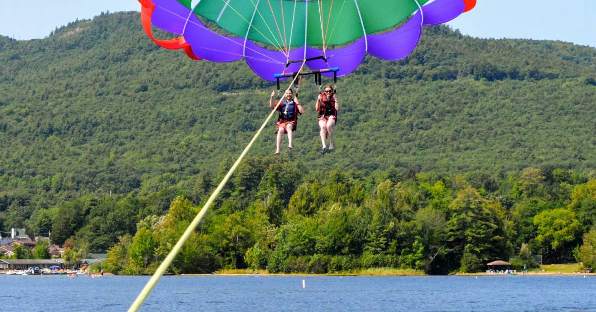 couple parasailing over lake george