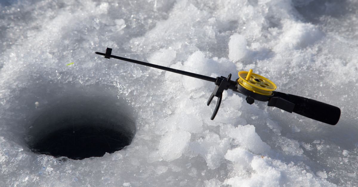 hole in ice and a small ice fishing pole