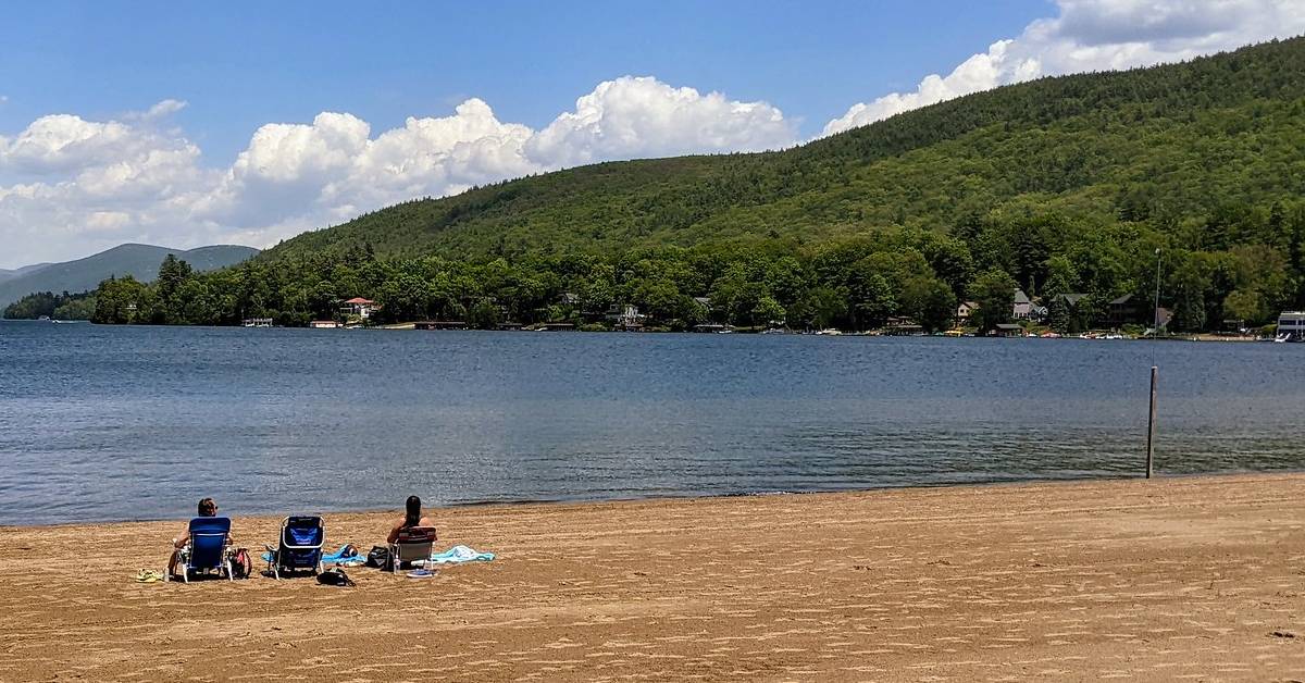 three people at million dollar beach in lake george