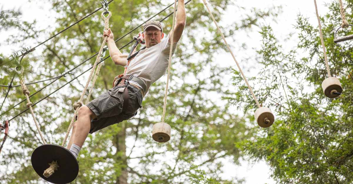 man traversing aerial park