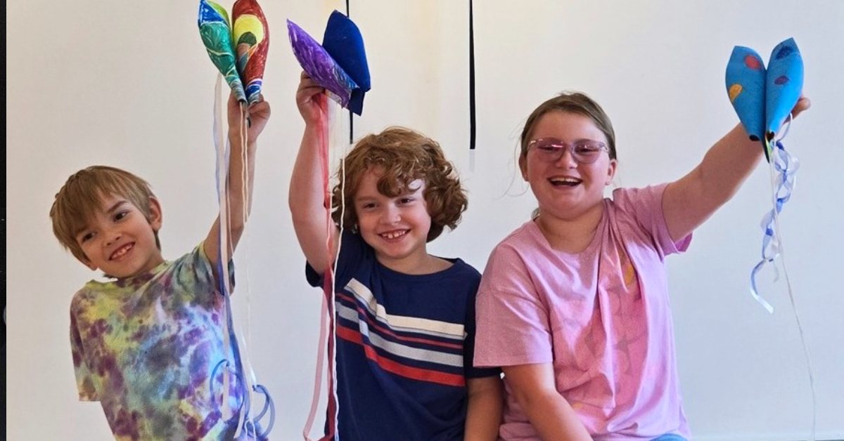 three kids with art projects