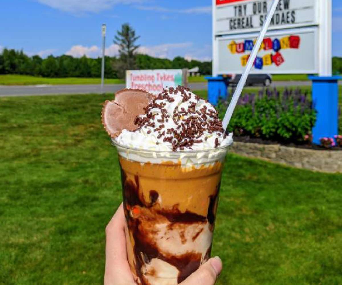 control tower ice cream with sundae held up in front of sign