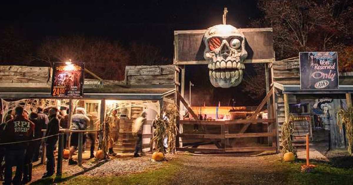 skull on top of a gate entrance of a haunted hayride