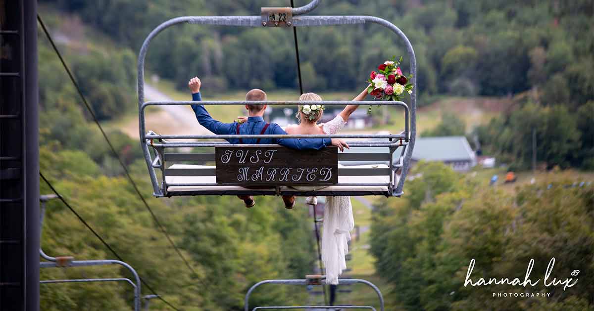 Newlyweds leave the ceremony by riding a ski lift down Oak Mountain.