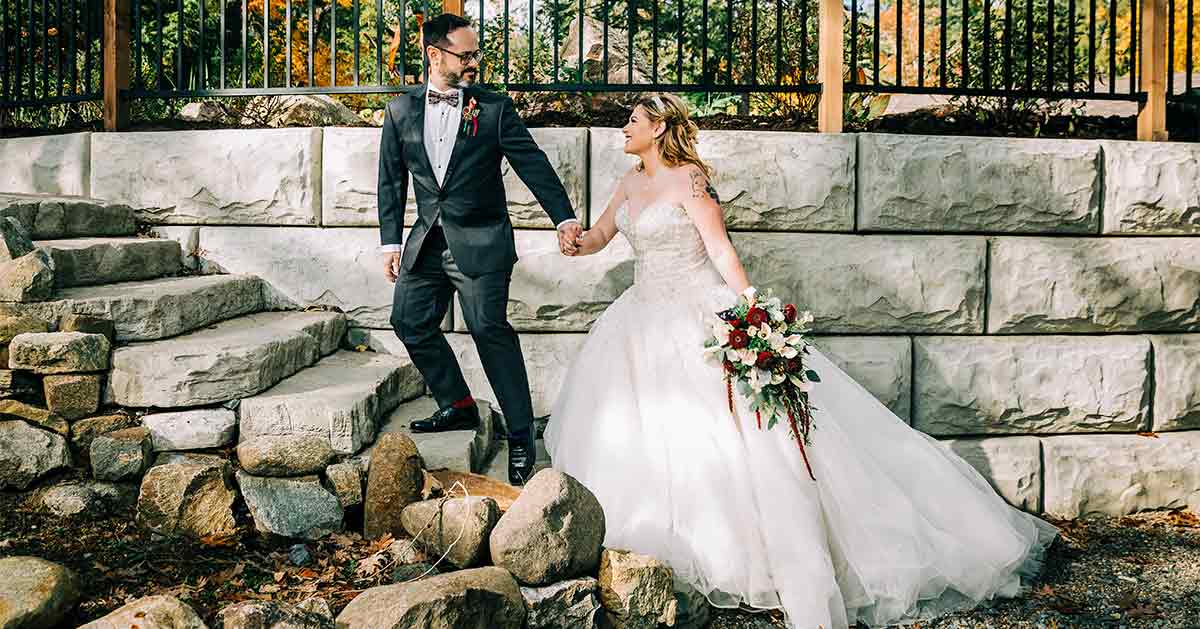 A couple runs up stone steps at Blue Water Manor