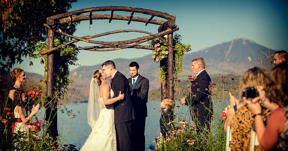 A ceremony with Lake Placid and Whiteface Mountain in the background.