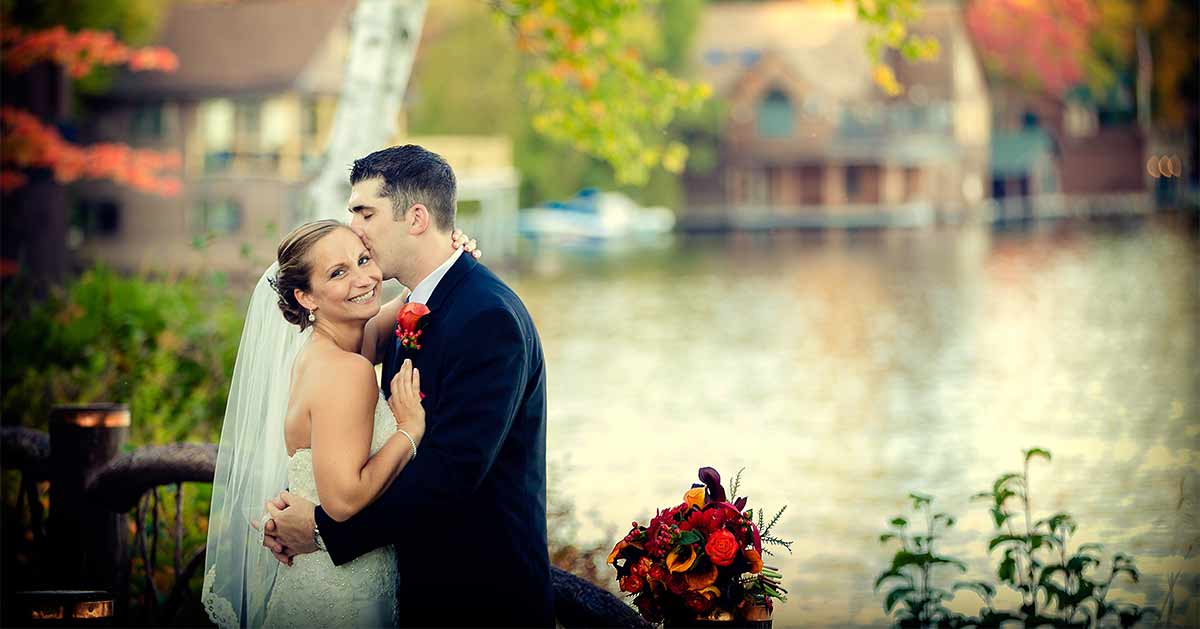 A couple poses by Lake Placid.