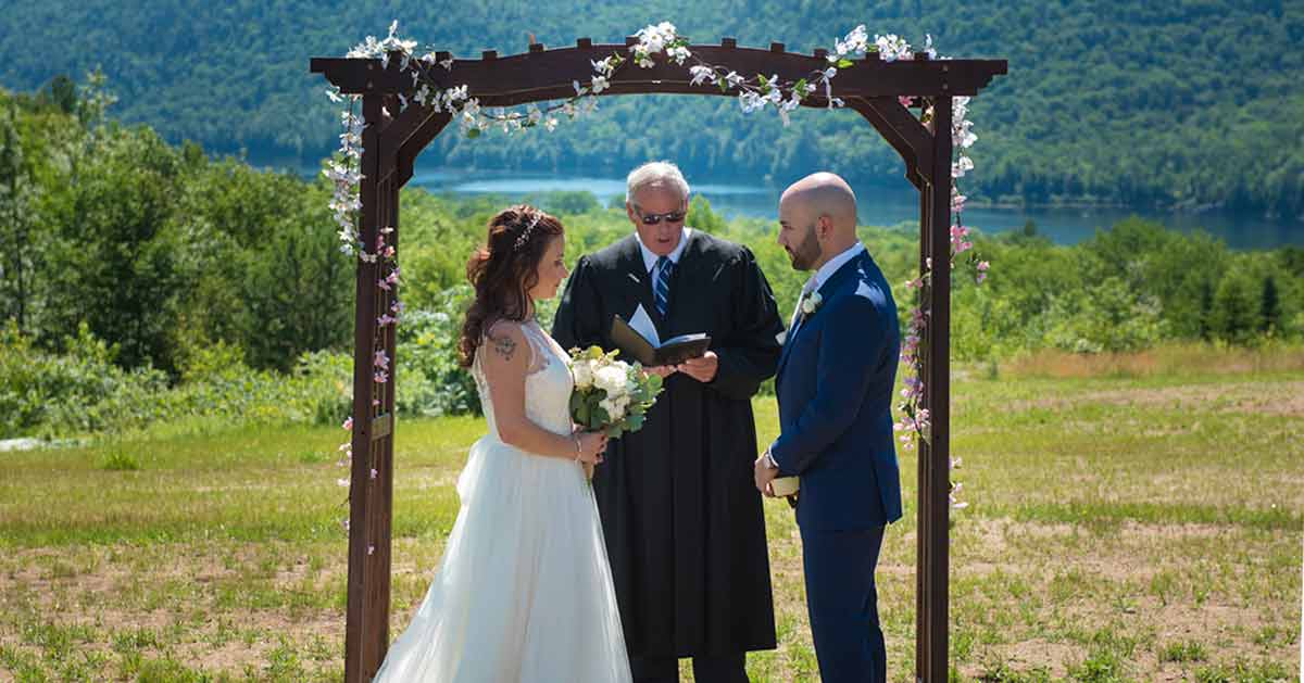 A couple says their vows atop a mountain at Garnet Hill Lodge.