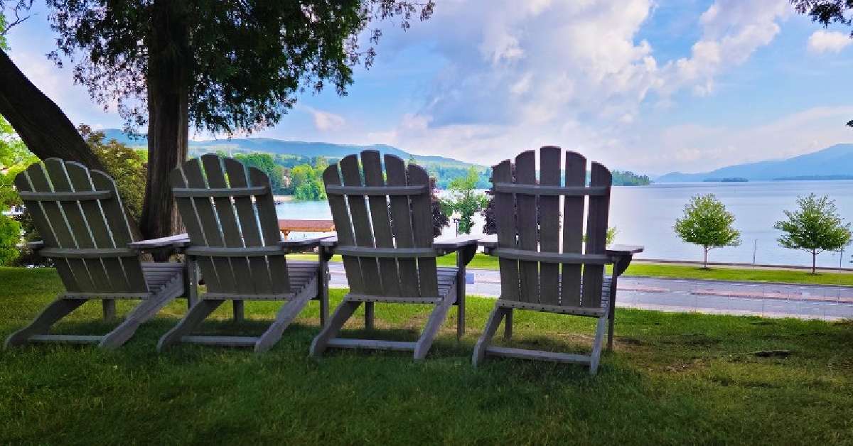Adirondack chairs facing a beautiful lake view