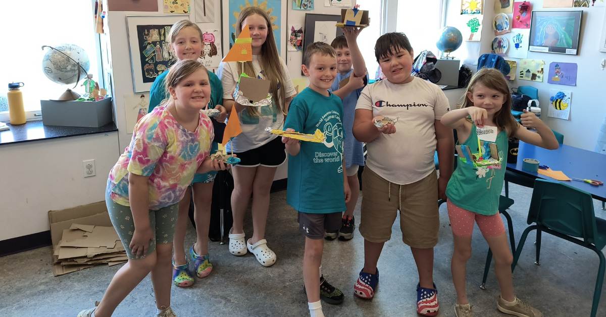group of kids with artworks