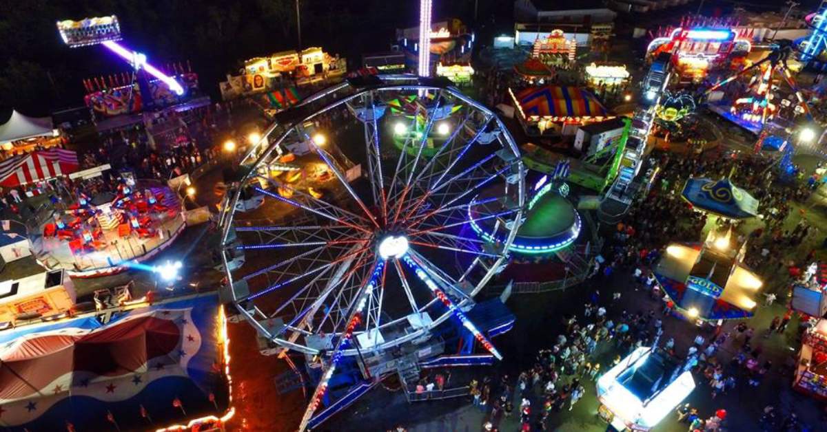aerial view of fair rides and booths at night
