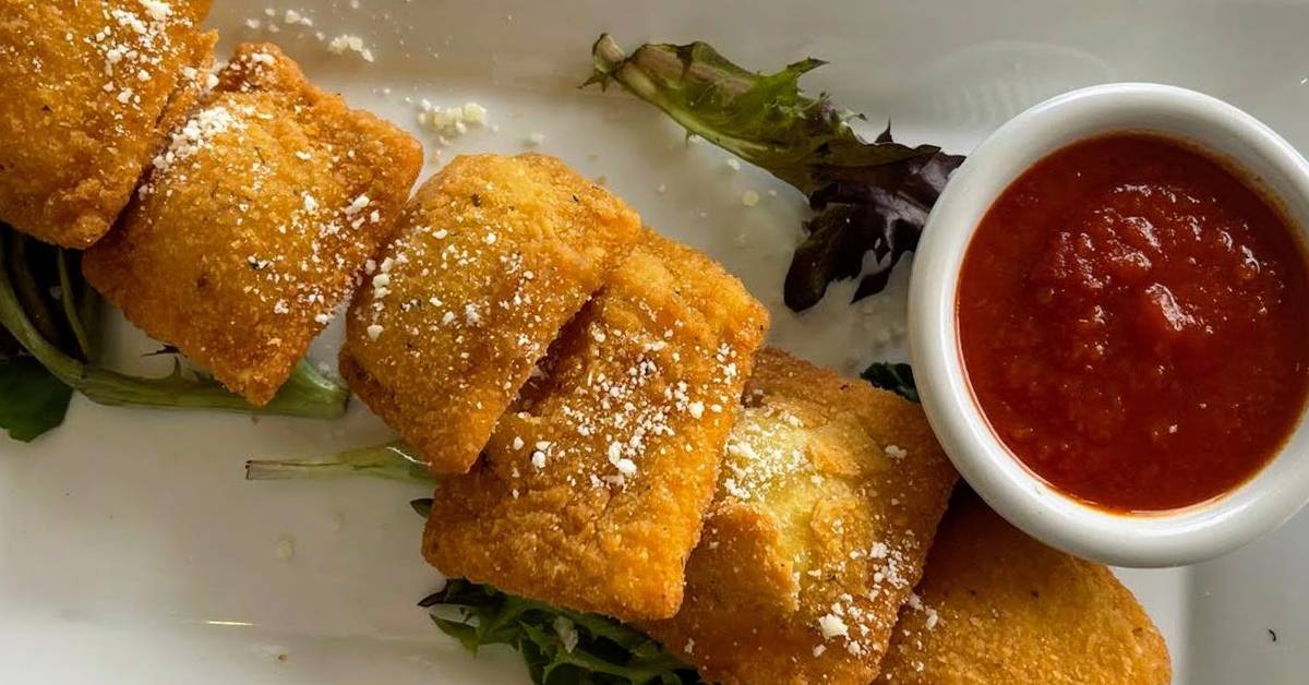 what looks like fried ravioli with dipping sauce