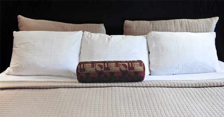 bed with beige and white linens