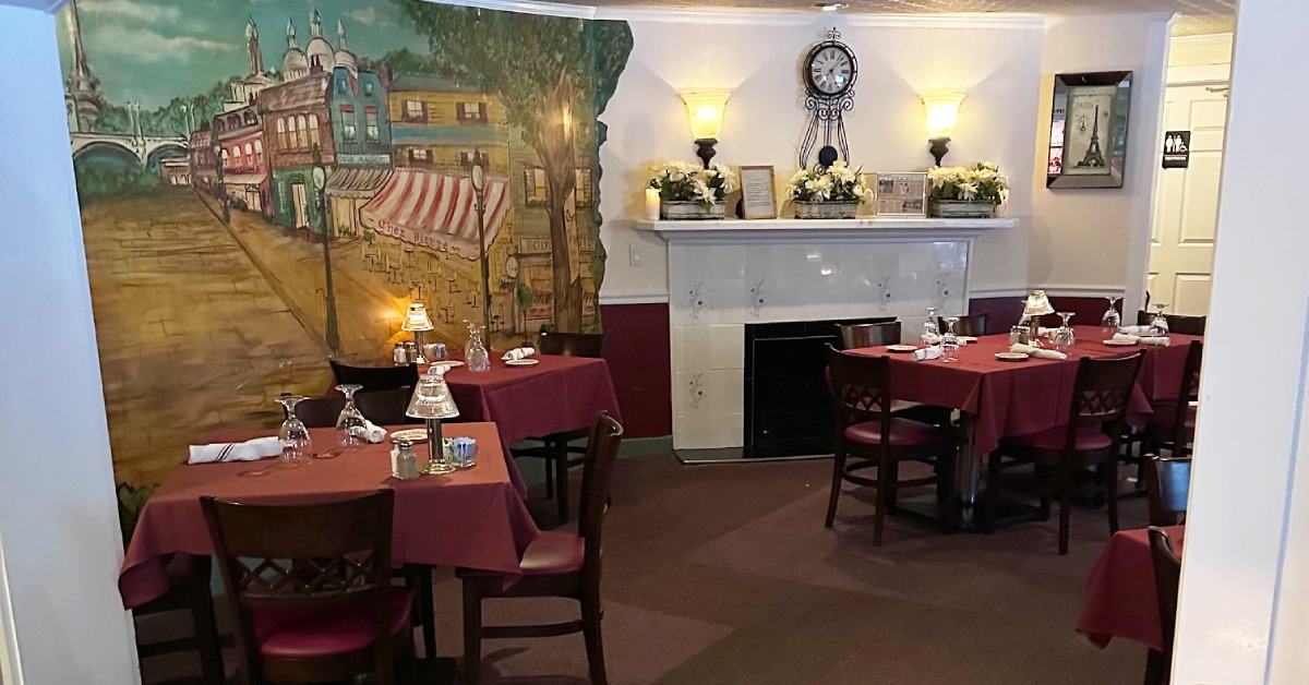a dining room with french themed mural