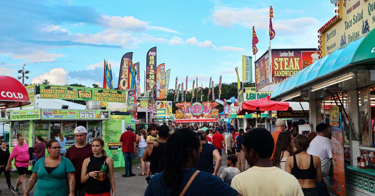 people walking around a county fair