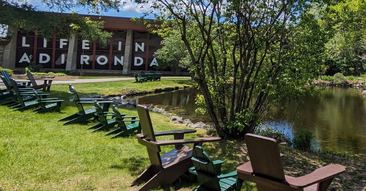 adirondack chairs and pond at adirondack experience at blue mountain lake