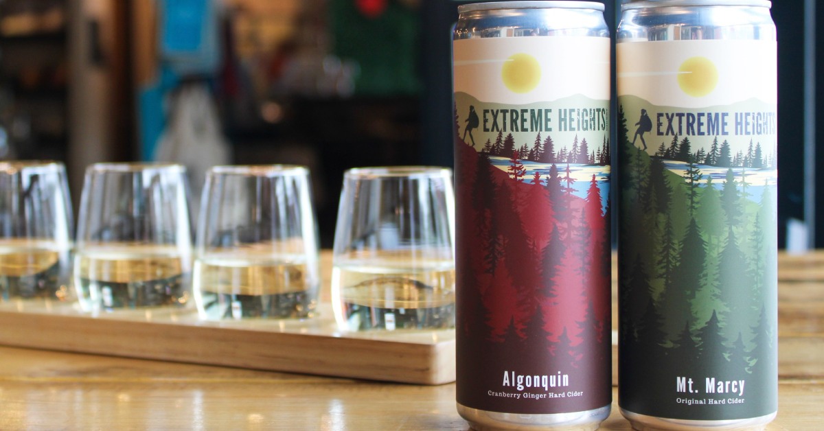 cider glasses and two cans of hard cider