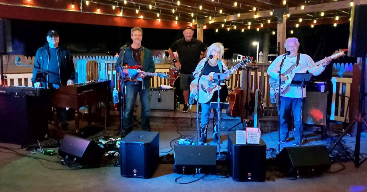 band performing on a pavilion stage in the evening