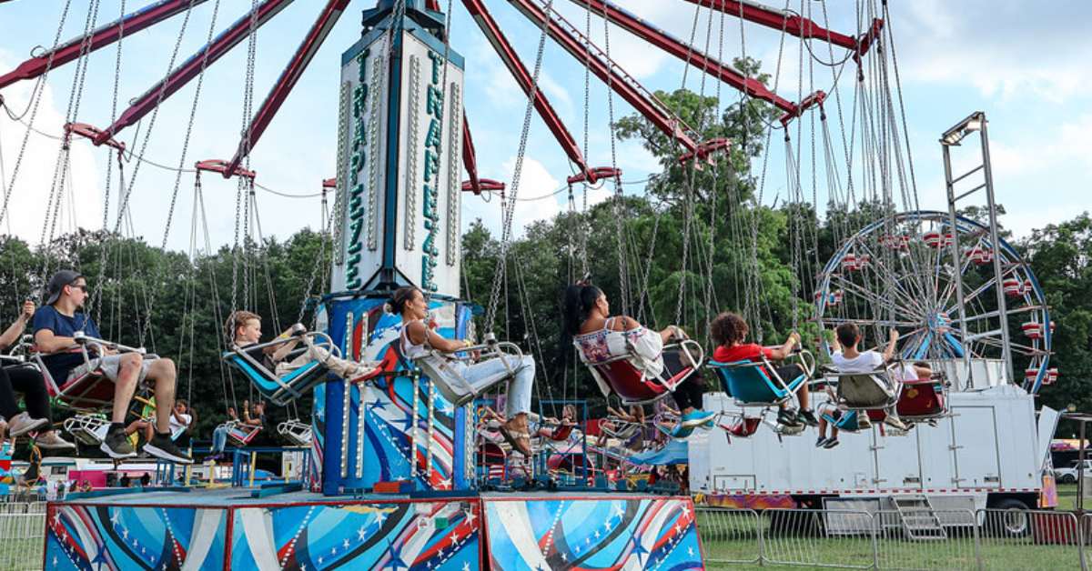 people seated on a spinning amusement ride