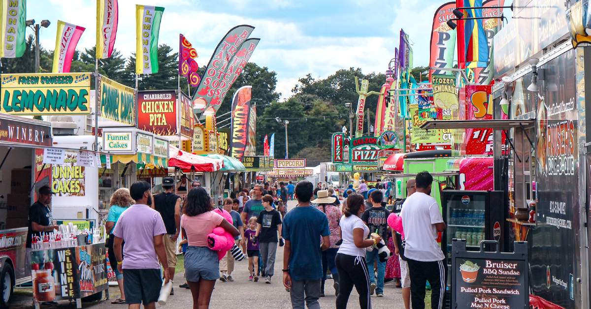 people walking around a county fair