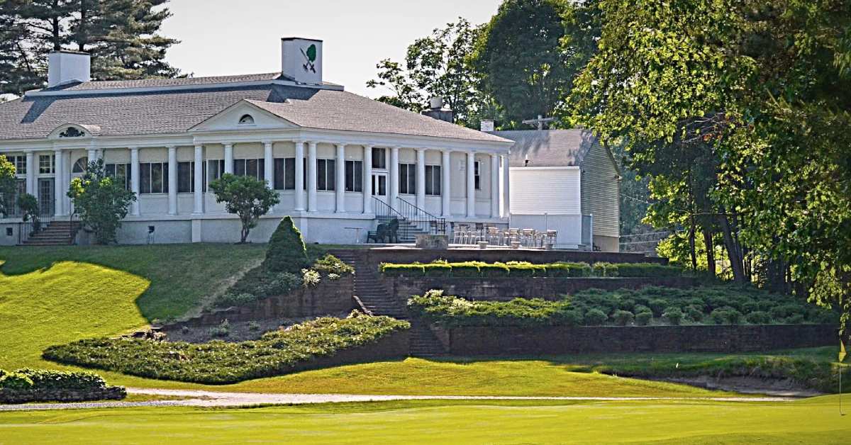 exterior of large white building at a golf course