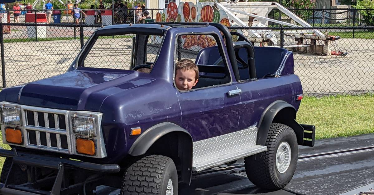 little kid in truck ride at huck finn's playland