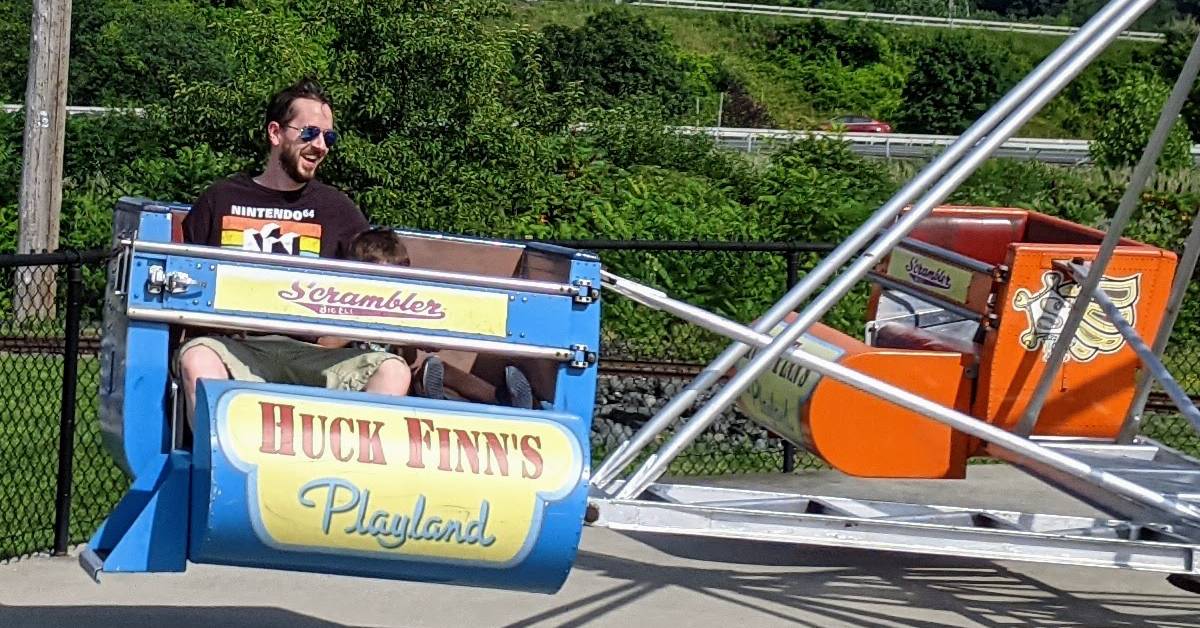 happy man on scrambler ride at huck finn's playland in albany