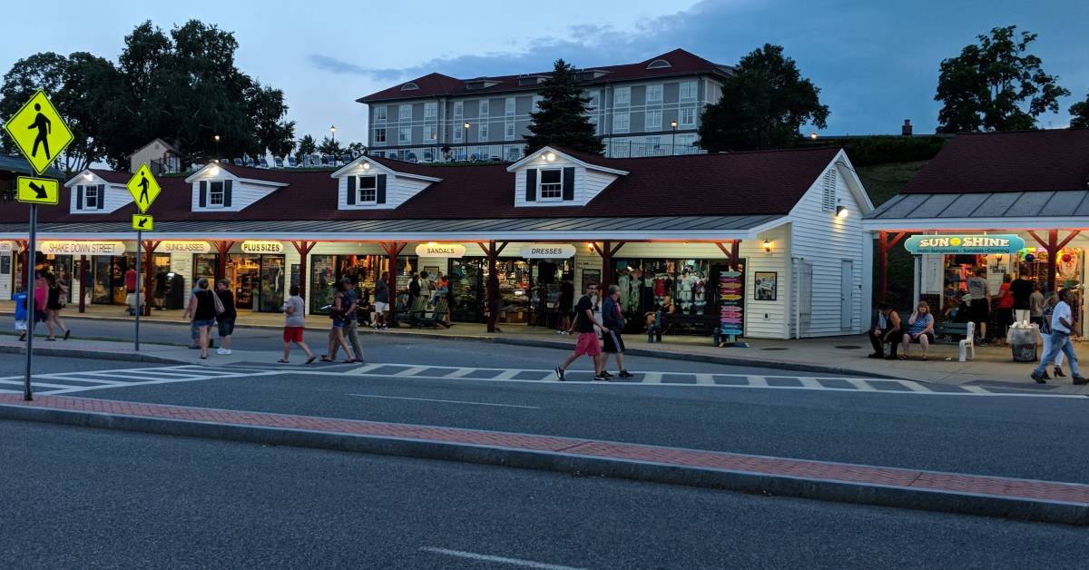 people walking along beach road at night in lake george