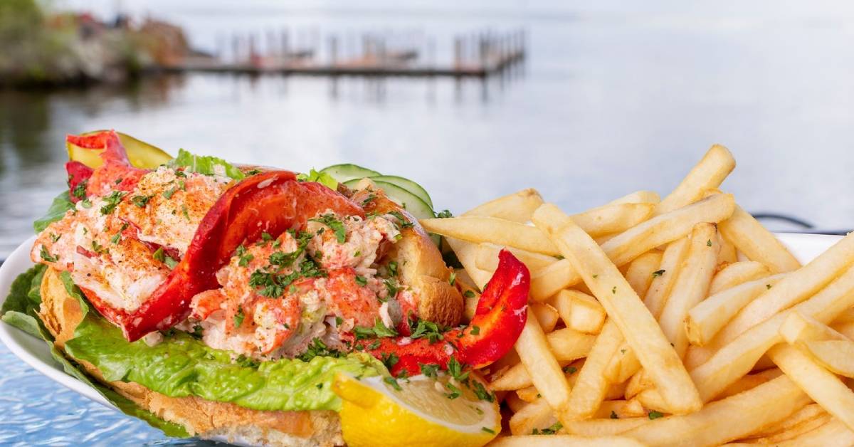 lobster roll with fries by the lake