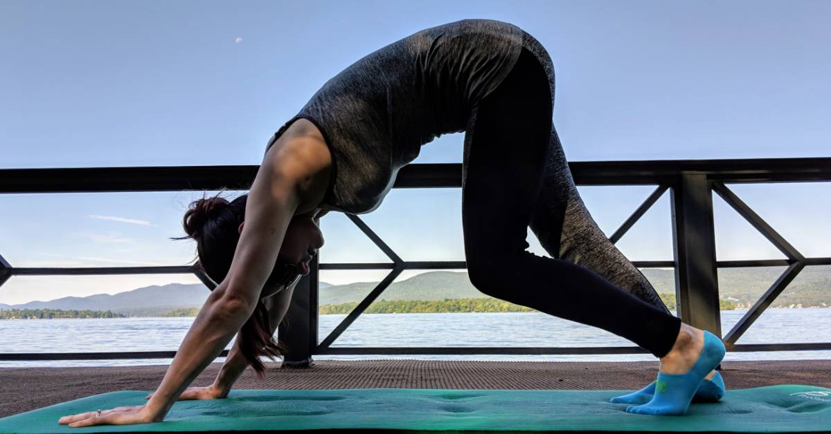 woman doing yoga by lake george