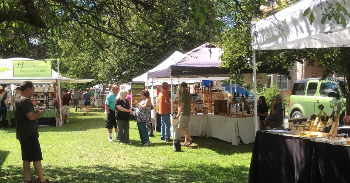 people walking around outdoor vendor tents