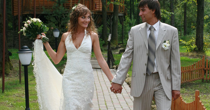 bride and groom holding hands