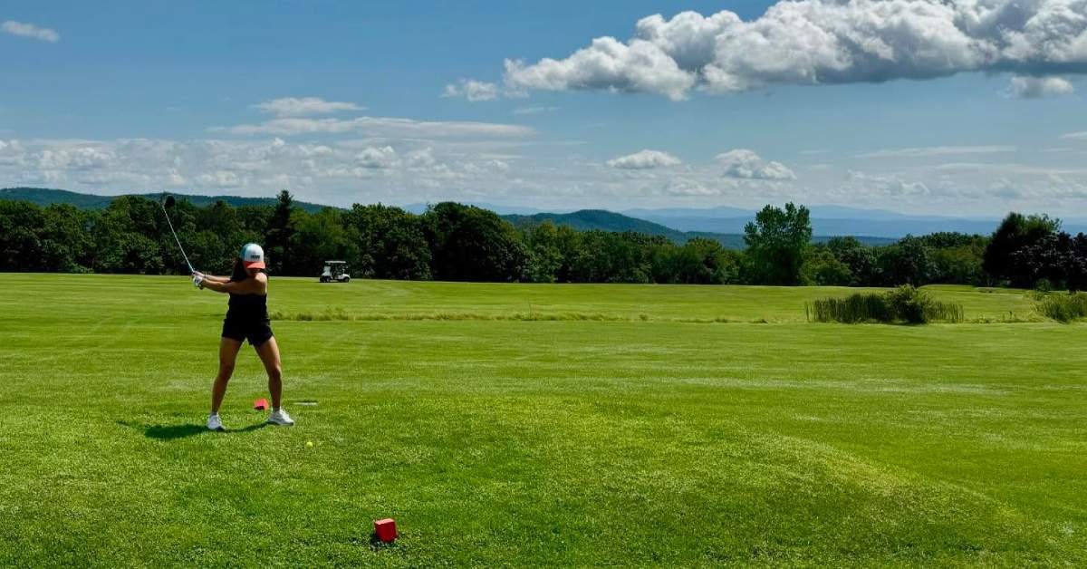side view of golfer preparing to swing