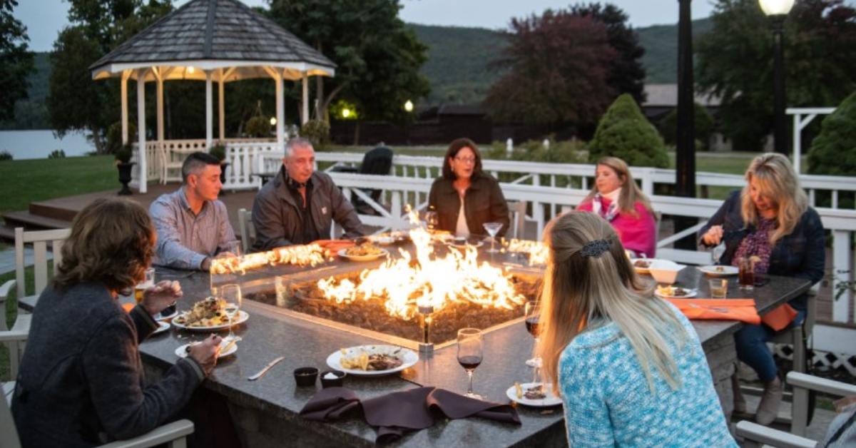 people seated around a fire pit table