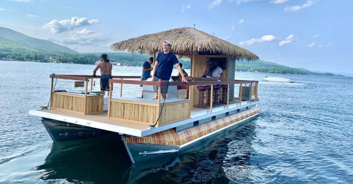 people on a tiki boat on a lake